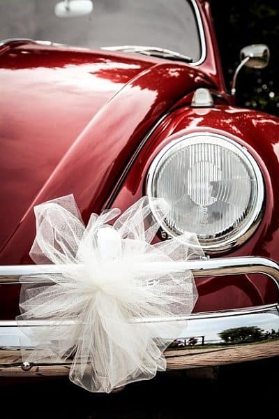 Beautiful red beetle decorated with white ribbons.