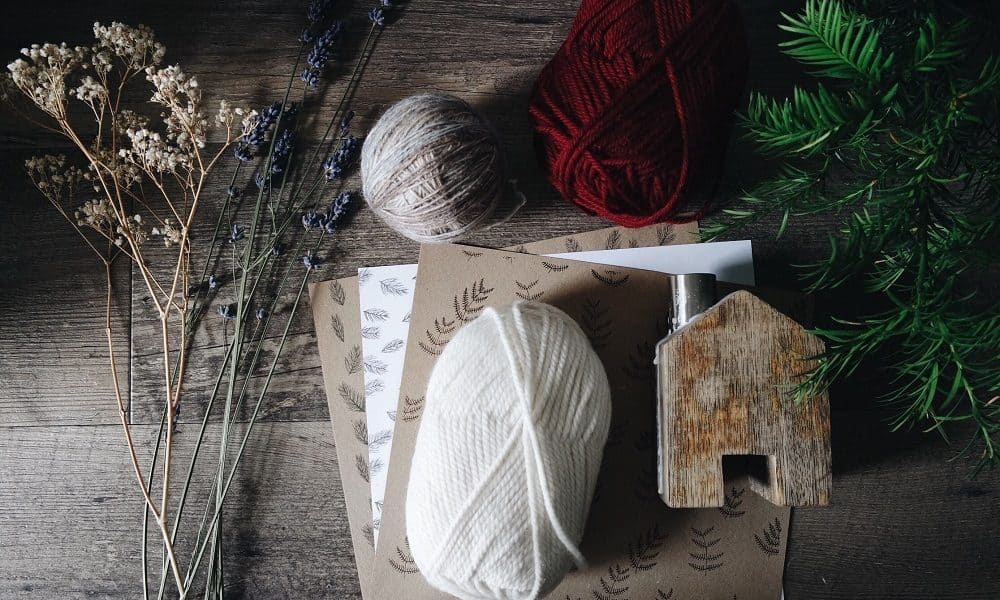 A work station with tools and materials neatly prepared and ready for crafts with dried flowers.