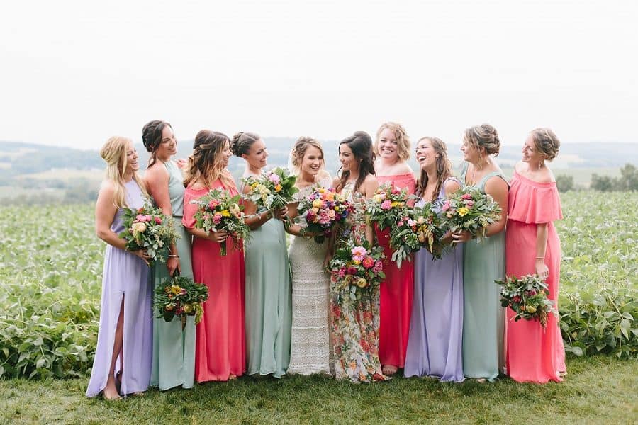 Pastel colored bridesmaids laughing