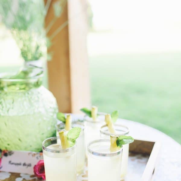 Close up of jug of lemonade and glasses.