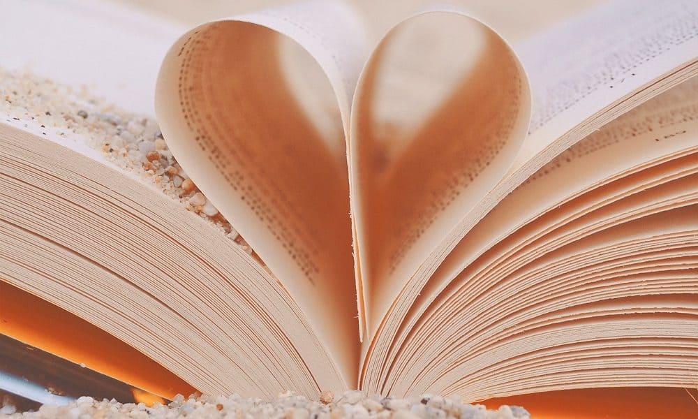 An open book with two pages folded to form a heart