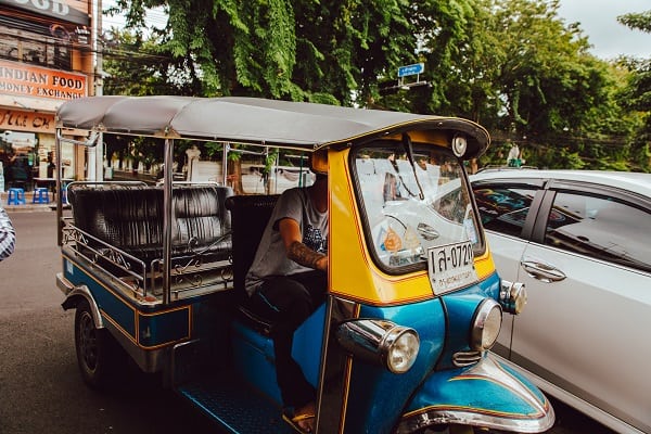 Tuk tuk with a bright blue lower body followed by block yellow.